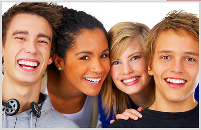 group of four smiling teenagers